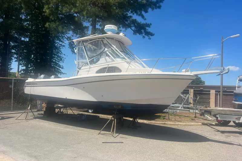 Slide: The Image of 2003 Grady-White Sailfish 282 boat on stands, outdoors under clear blue sky. - 3