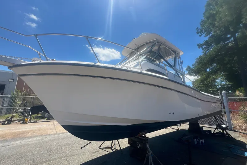 Slide: The Image of 2003 Grady-White Sailfish 282 boat on stands under a clear blue sky. - 5