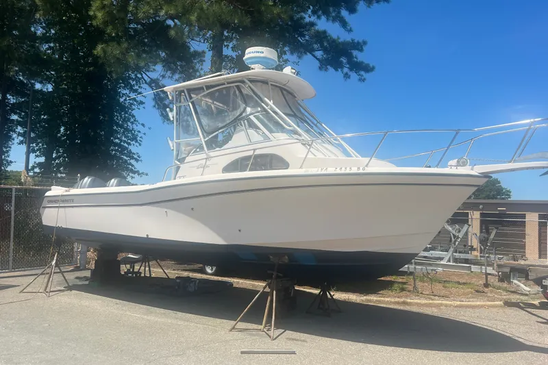 Slide: The Image of 2003 Grady-White Sailfish 282 boat on stands, outdoors under clear blue sky. - 4