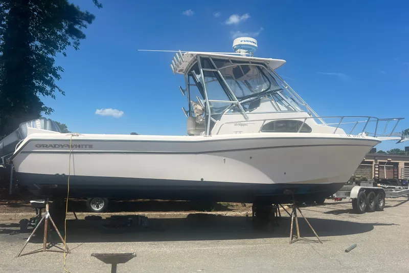 Slide: The Image of 2003 Grady-White Sailfish 282 boat on trailer under clear blue sky. - 0