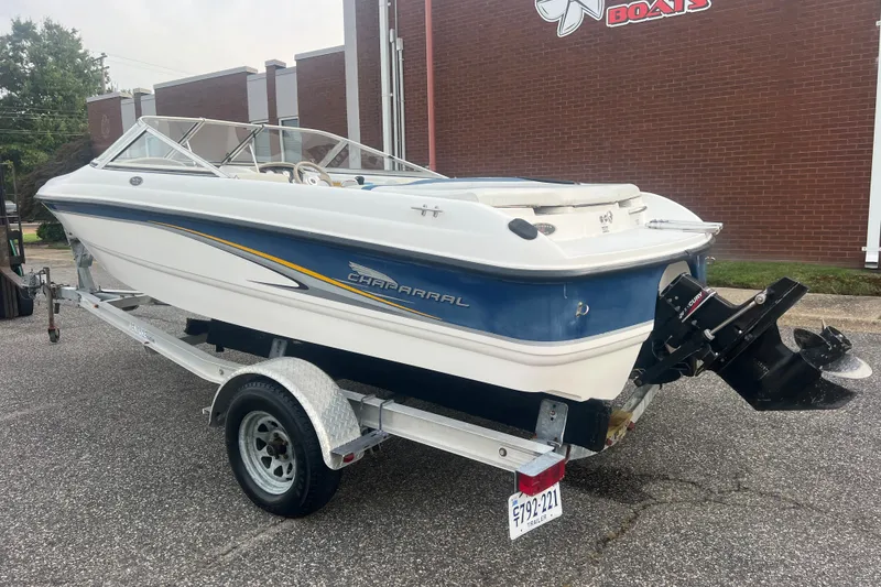 Slide: The Image of 2002 Chaparral 180 SSe boat on trailer, parked outside a brick building. - 32