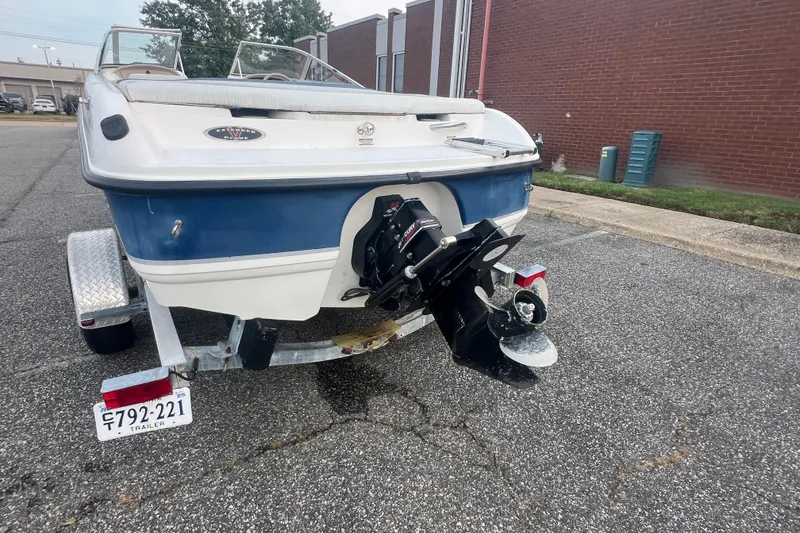 Slide: The Image of 2002 Chaparral 180 SSe boat on trailer, rear view showing outboard motor. - 52