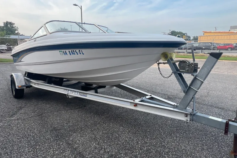 Slide: The Image of 2002 Chaparral 180 SSe boat on trailer, parked outdoors, ready for transport. - 36