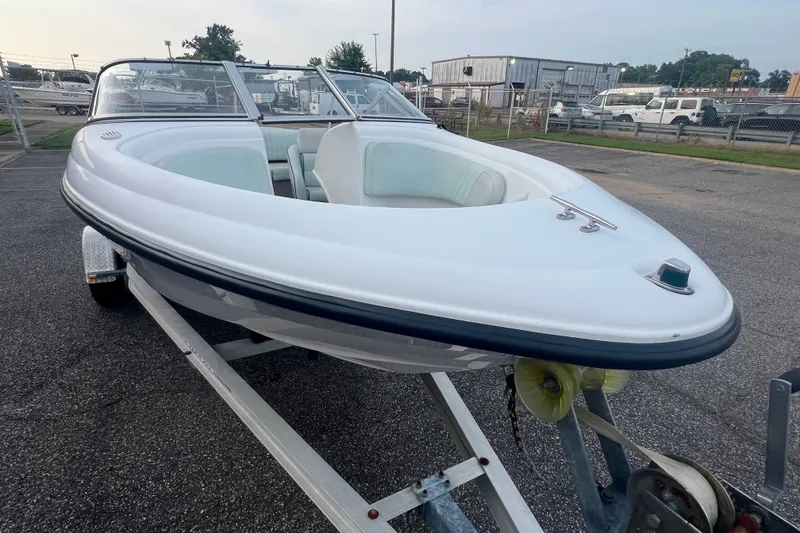 Slide: The Image of 2002 Chaparral 180 SSe boat on trailer, parked outdoors, showcasing sleek design. - 37