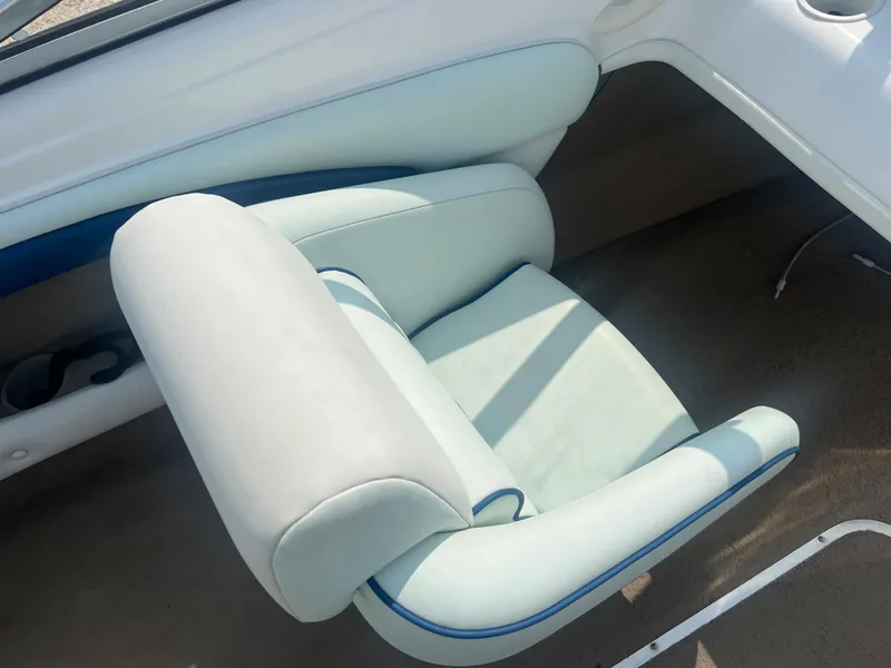 Slide: The Image of A seat inside a boat with light blue upholstery and white accents. - 18