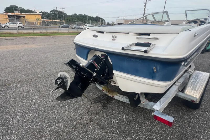 Slide: The Image of 2002 Chaparral 180 SSe boat on trailer, rear view showing outboard motor and ladder. - 51