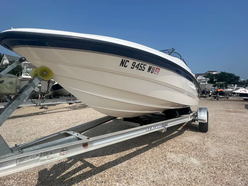 Slide: The Image of A 2002 Chaparral 180 SSe boat on a trailer, parked on a gravel lot. - 27
