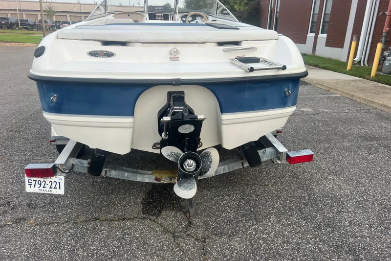 Slide: The Image of 2002 Chaparral 180 SSe boat on trailer, rear view, parked on asphalt. - 33