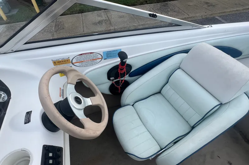 Slide: The Image of Interior of a 2002 Chaparral 180 SSe boat with steering wheel and seat. - 45