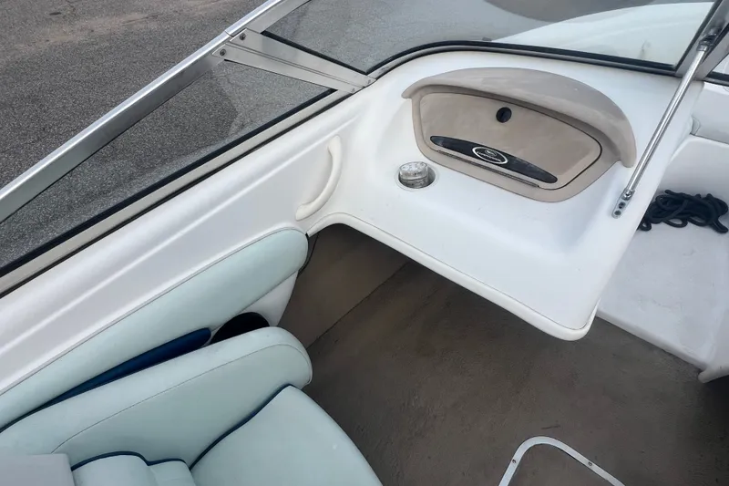 Slide: The Image of Interior of a 2002 Chaparral 180 SSe boat, featuring seating and dashboard details. - 40