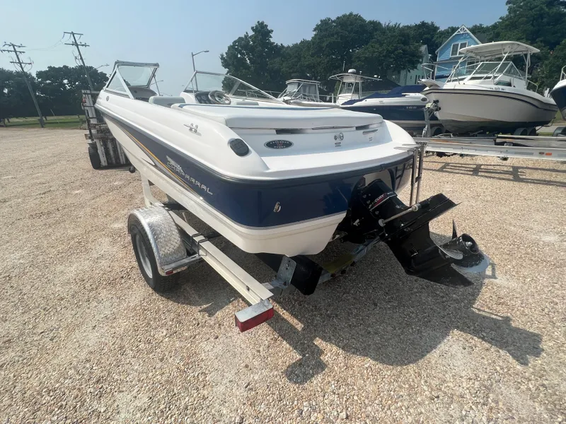 Slide: The Image of A 2002 Chaparral 180 SSe boat on a trailer in a gravel lot. - 29