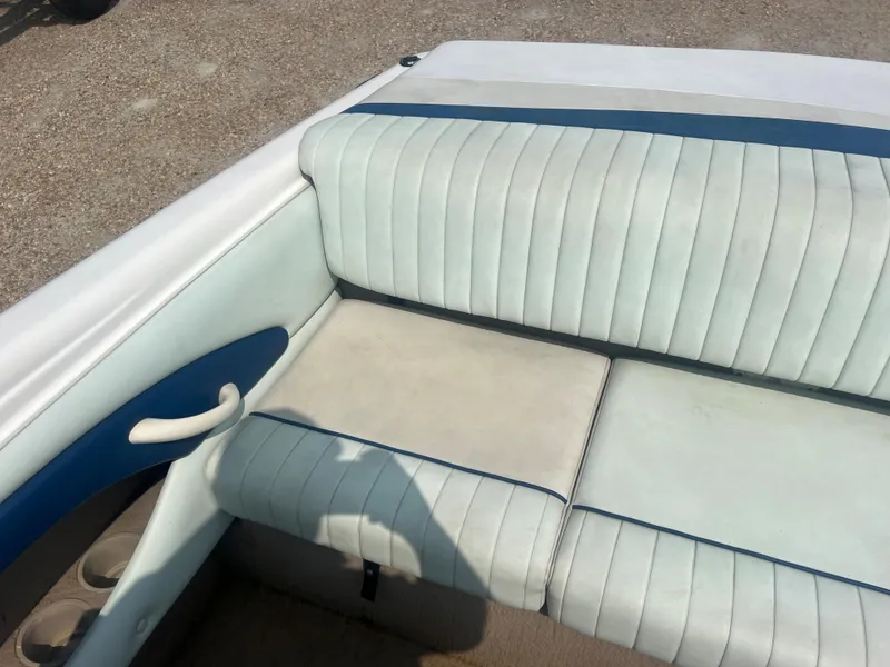 Slide: The Image of The image shows the rear seating of a 2002 Chaparral 180 SSe with white and blue upholstery. - 19