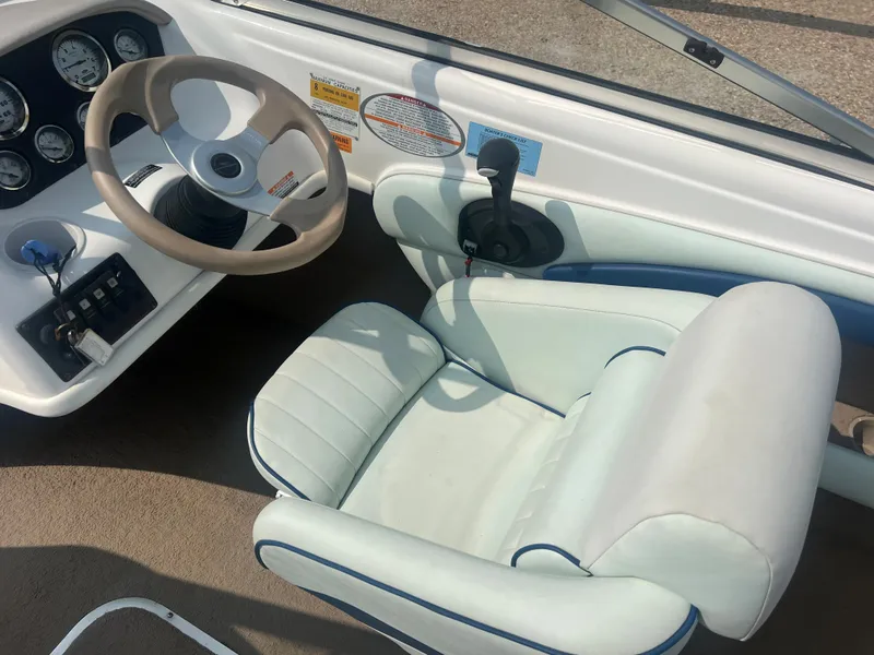 Slide: The Image of The image shows the cockpit of a 2002 Chaparral 180 SSe with a steering wheel and instruments. - 15