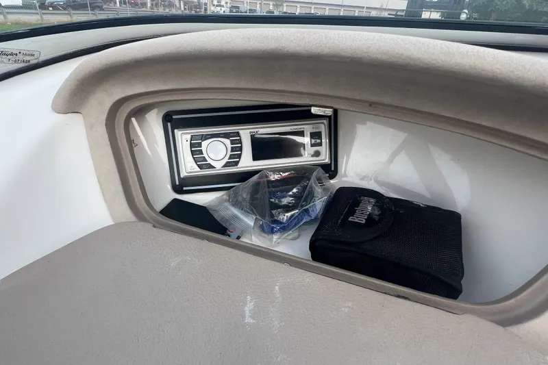 Slide: The Image of 2002 Chaparral 180 SSe boat dashboard with stereo system and storage compartment. - 41