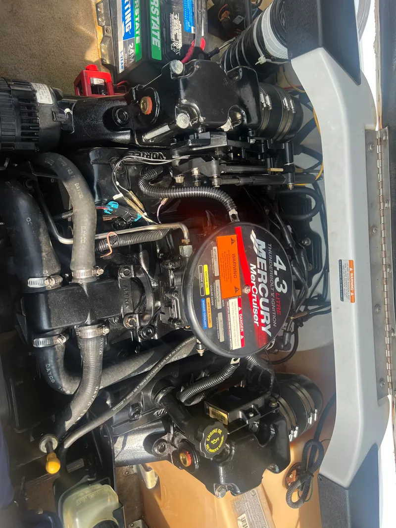 Slide: The Image of A Mercury 4.3 engine in a 2002 Chaparral 180 SSe boat, with visible hoses and cables. - 22