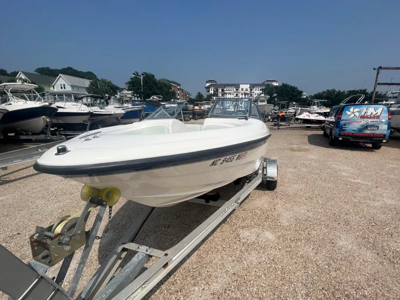 Slide: The Image of A 2002 Chaparral 180 SSe boat on a trailer in a gravel lot. - 28