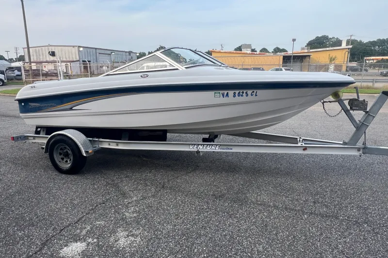 Slide: The Image of 2002 Chaparral 180 SSe boat on trailer, parked outdoors on asphalt. - 35