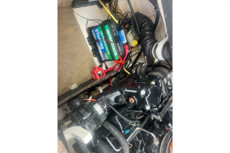 Slide: The Image of Engine compartment of a 2002 Chaparral 180 SSe boat with visible battery and wiring. - 54