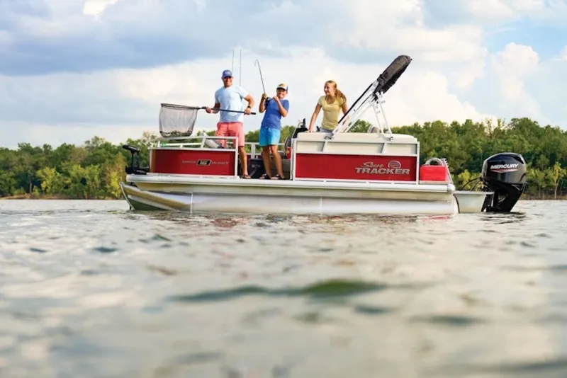 The Image of 2027 Sun Tracker Bass Buggy 16 XL Select pontoon boat on a lake with three people fishing. - 1