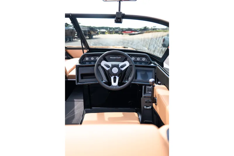 Slide: The Image of 2027 MasterCraft NXT24 boat cockpit with modern steering wheel and digital controls. - 41