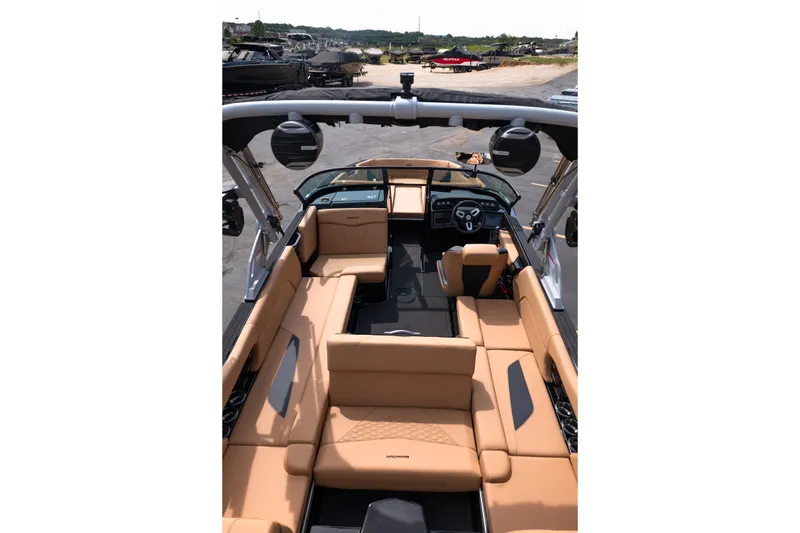 Slide: The Image of 2027 MasterCraft NXT24 boat interior with tan seating and modern dashboard. - 36