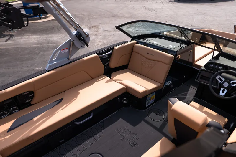 Slide: The Image of Luxurious interior of 2027 MasterCraft NXT24 boat with tan seating and modern dashboard. - 23