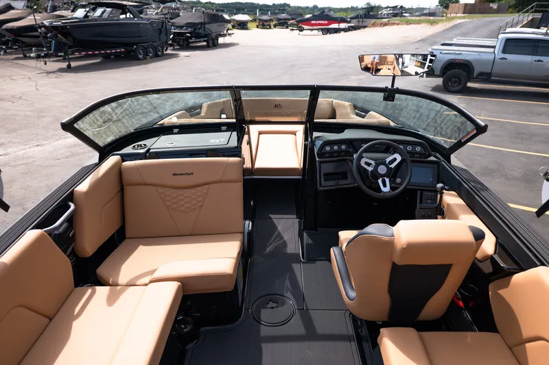 Slide: The Image of 2027 MasterCraft NXT24 boat interior with tan seating and modern dashboard design. - 30