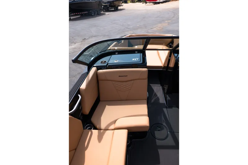 Slide: The Image of 2027 MasterCraft NXT24 boat interior with tan seating and sleek design. - 29