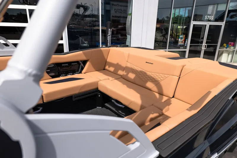 Slide: The Image of 2027 MasterCraft NXT24 boat interior with tan seating and modern design. - 18