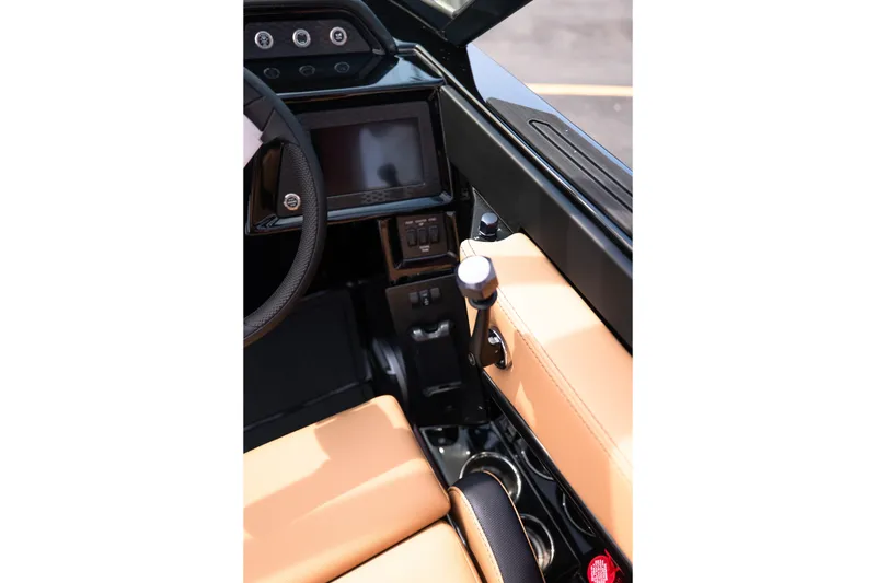 Slide: The Image of Interior view of 2027 MasterCraft NXT24 boat cockpit with steering wheel and control panel. - 43