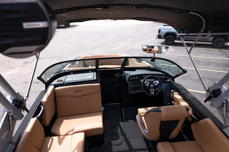 Slide: The Image of Interior view of 2027 MasterCraft NXT24 boat with tan seating and modern dashboard. - 47