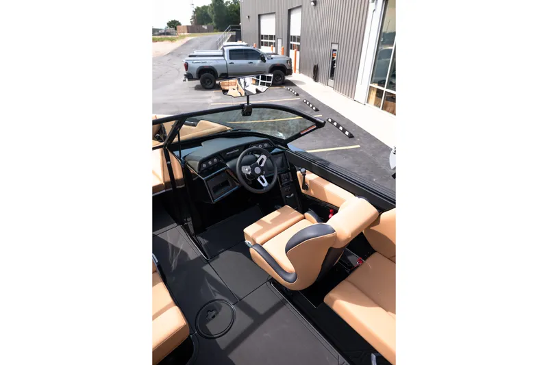 Slide: The Image of Interior view of 2027 MasterCraft NXT24 boat with tan seating and modern dashboard. - 28