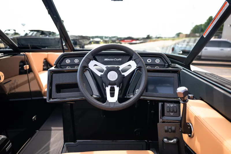 Slide: The Image of 2027 MasterCraft NXT24 boat cockpit with modern steering wheel and dashboard controls. - 40