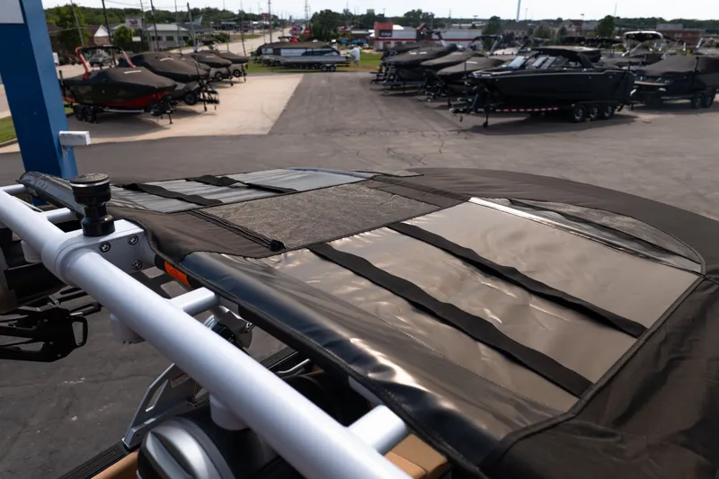 Slide: The Image of 2027 MasterCraft NXT24 boat with cover, displayed in a dealership lot. - 49