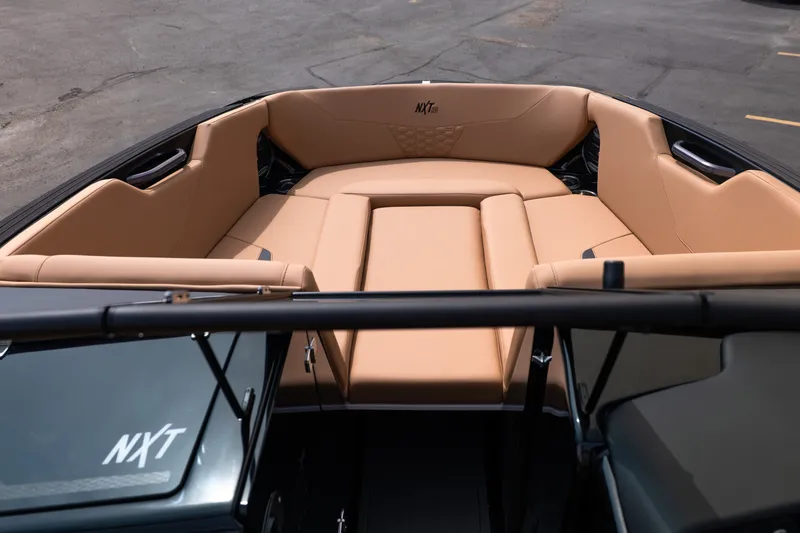 Slide: The Image of 2027 MasterCraft NXT24 boat interior with tan seating and sleek design. - 42