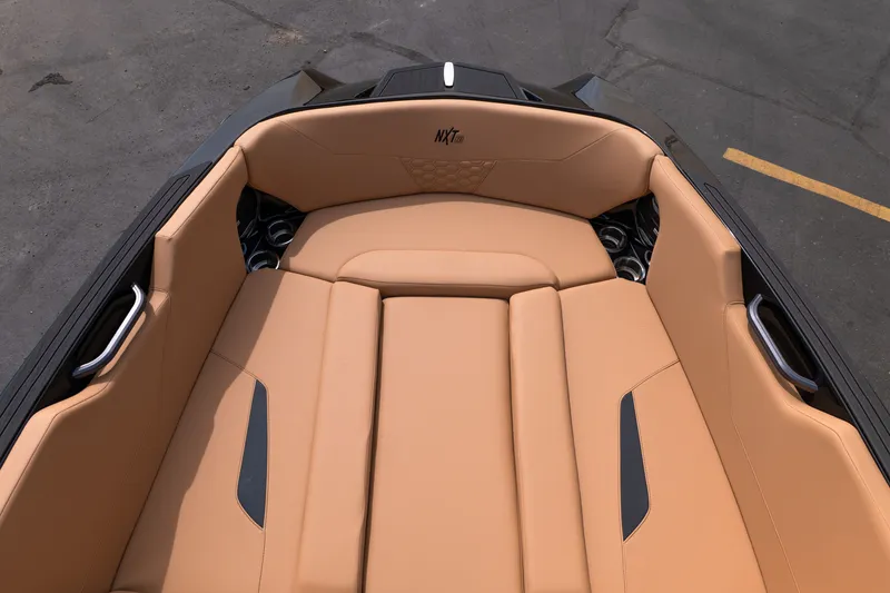 Slide: The Image of 2027 MasterCraft NXT24 boat interior with tan seating and sleek design. - 45