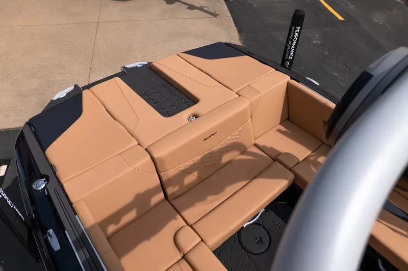 Slide: The Image of 2027 MasterCraft NXT24 boat interior with tan seating and black accents. - 22