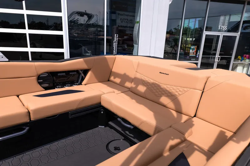 Slide: The Image of 2027 MasterCraft NXT24 boat interior with tan seating and modern design. - 19