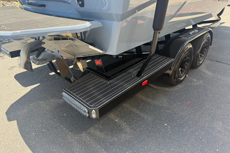 Slide: The Image of Rear view of 2026 MB B52 23 Alpha boat on trailer, showcasing propeller and dual axles. - 11