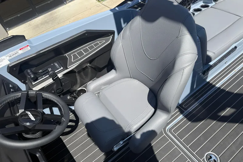 Slide: The Image of 2026 MB B52 23 Alpha boat interior with gray captain's seat and steering wheel. - 15
