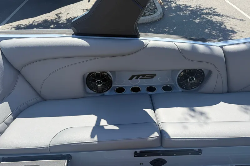 Slide: The Image of Interior of 2026 MB B52 23 Alpha boat with sleek seating and built-in speakers. - 22