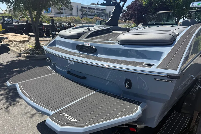 Slide: The Image of 2026 MB B52 23 Alpha boat with sleek design and modern features, parked outdoors. - 13
