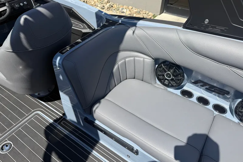 Slide: The Image of Interior of 2026 MB B52 23 Alpha boat with gray seating and built-in speakers. - 17