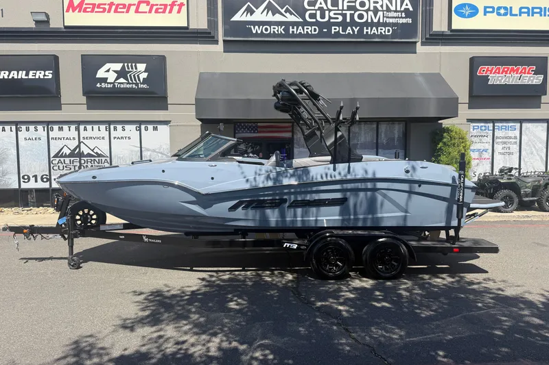 Slide: The Image of 2026 MB B52 23 Alpha boat on trailer at California Custom Trailers dealership. - 2