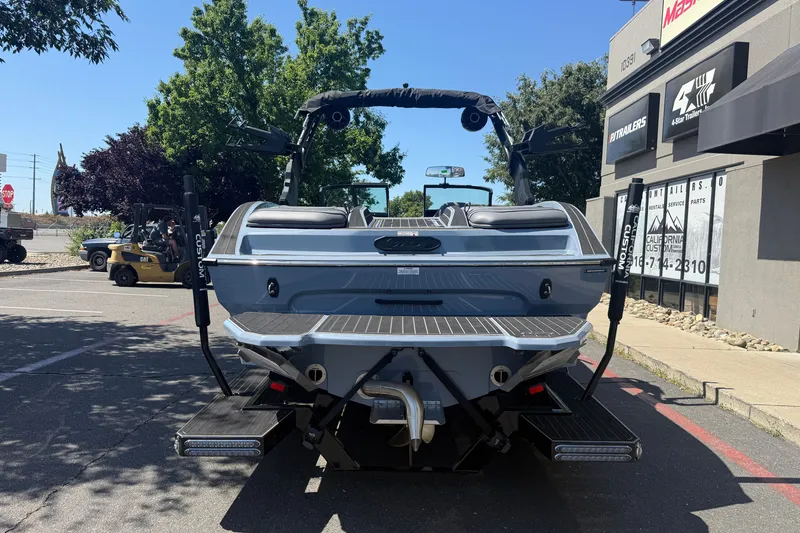 Slide: The Image of 2026 MB B52 23 Alpha boat parked outside dealership, rear view. - 4