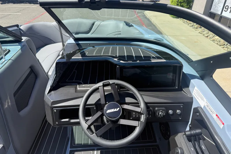 Slide: The Image of 2026 MB B52 23 Alpha boat cockpit with steering wheel and dashboard controls. - 14