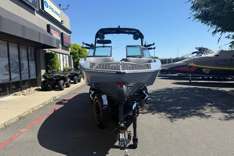 Slide: The Image of 2026 MB B52 23 Alpha boat on trailer outside dealership, sunny day. - 7