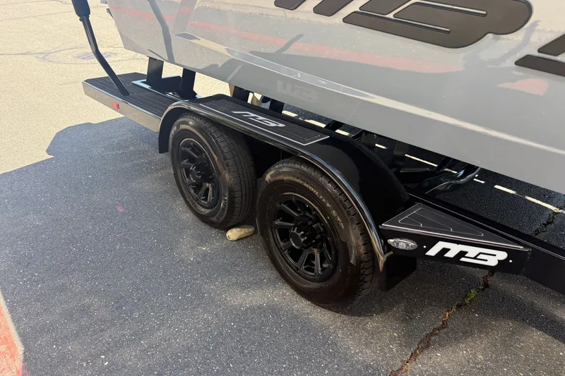 Slide: The Image of Trailer of 2026 MB B52 23 Alpha with black wheels on pavement. - 10