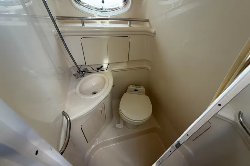 Slide: The Image of Compact bathroom in 2001 Sea Ray Sundancer 280 yacht, featuring sink and toilet. - 32