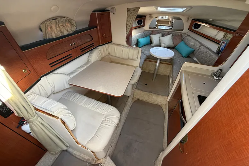Slide: The Image of Interior of 2001 Sea Ray Sundancer 280 with cozy seating and dining area. - 19